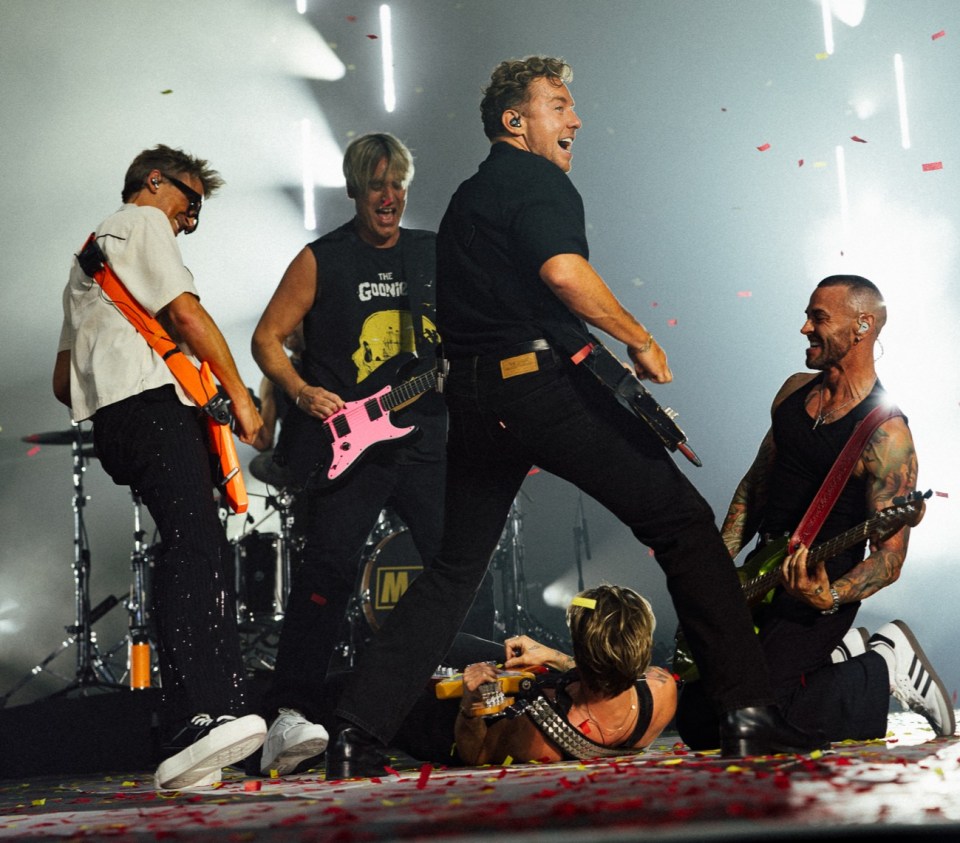McFly and Busted perform on stage together with confetti falling.