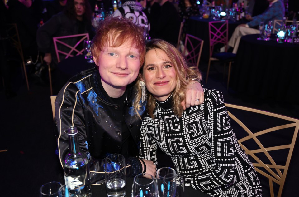 Ed Sheeran and Cherry Seaborn smiling at The BRIT Awards 2022.