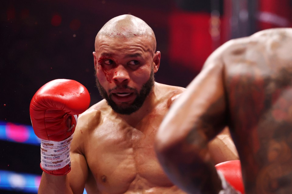 Chris Eubank Jr. looks on with a cut above his eye during a boxing match.