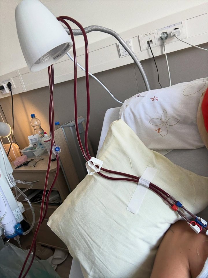 Patient undergoing an IV treatment in a hospital bed.