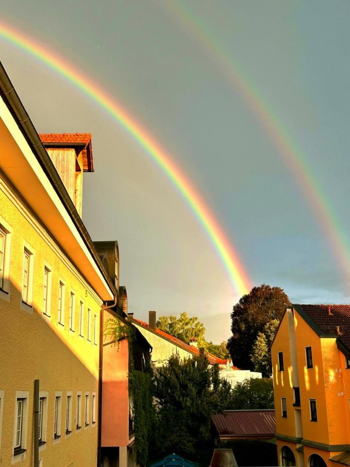 A double rainbow over European buildings.