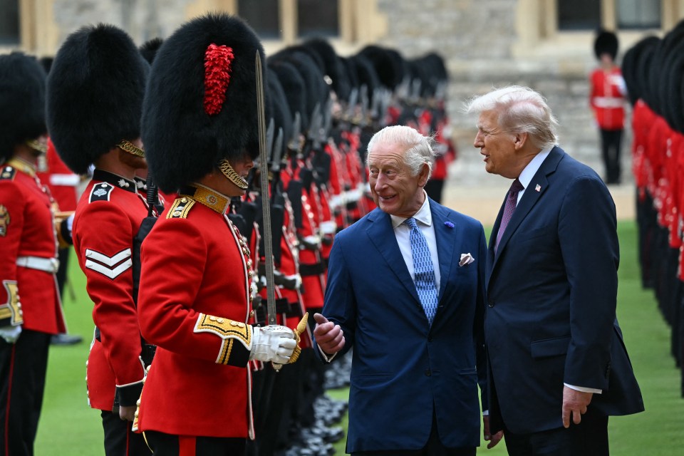 King Charles III and Donald Trump talk with a Coldstream Guardsman during a ceremonial welcome at Windsor Castle.