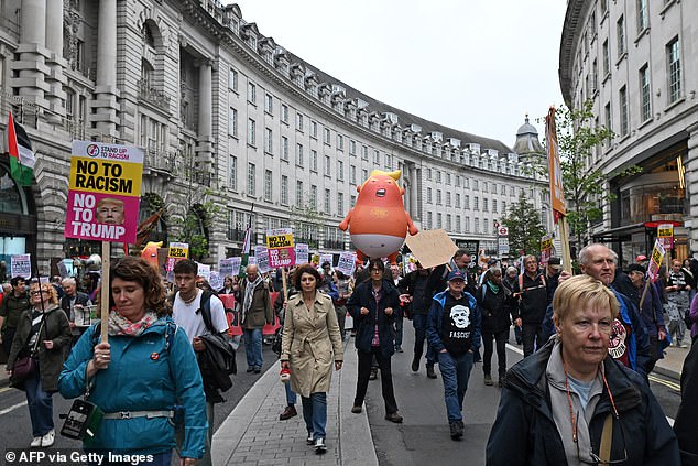 Anti-Trump protesters take part in a march during a demonstration against the second State Visit of US President Donald Trump in central London on September 17, 2025. Donald Trump was welcomed by King Charles III to Windsor Castle Wednesday with a royal spectacle featuring gun salutes, mounted horses and bagpipes as the US president's historic second state visit got into full swing. (Photo by JUSTIN TALLIS / AFP) (Photo by JUSTIN TALLIS/AFP via Getty Images)