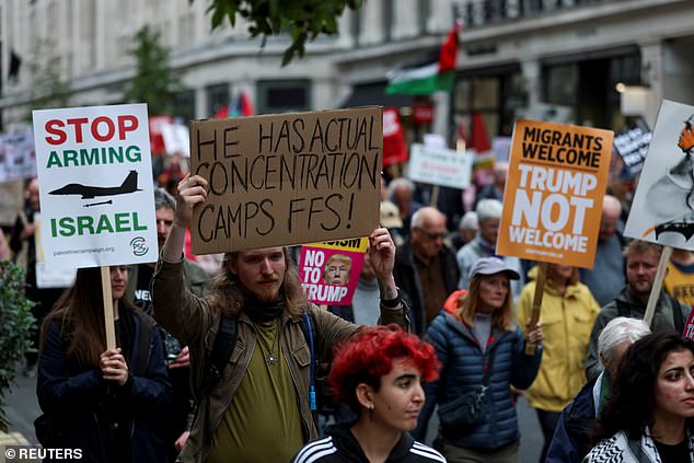 Demonstrators hold signs and placards on the day of a 'Trump Not Welcome' protest during the state visit of U.S. President Donald Trump and first lady Melania Trump, in London, Britain, September 17, 2025. REUTERS/Hannah McKay