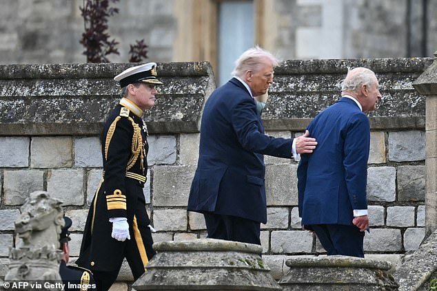 US President Donald Trump (C) places his hand on Britain's King Charles III's back as they leave the Beating Retreat military ceremony on the East Lawn at Windsor Castle, in Windsor, on September 17, 2025, during the US president's second State Visit. US President Donald Trump arrived in Britain for an unprecedented second State Visit, with the UK government rolling out a royal red carpet welcome to win over the mercurial leader. (Photo by ANDREW CABALLERO-REYNOLDS / AFP) (Photo by ANDREW CABALLERO-REYNOLDS/AFP via Getty Images)
