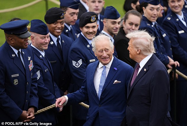 Britain's King Charles III and US President Donald Trump speak to military personnel following a Beating Retreat military ceremony on the East Lawn at Windsor Castle, in Windsor, on September 17, 2025, during the US President's second State Visit. US President Donald Trump arrived in Britain for an unprecedented second State Visit, with the UK government rolling out a royal red carpet welcome to win over the mercurial leader. (Photo by Jordan Pettitt / POOL / AFP) (Photo by JORDAN PETTITT/POOL/AFP via Getty Images)