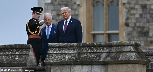 Britain's King Charles III (C) and US President Donald Trump (R) are directed by an officer to attend the Beating Retreat military ceremony on the East Lawn at Windsor Castle, in Windsor, on September 17, 2025, during the US president's second State Visit. US President Donald Trump arrived in Britain for an unprecedented second State Visit, with the UK government rolling out a royal red carpet welcome to win over the mercurial leader. (Photo by ANDREW CABALLERO-REYNOLDS / AFP) (Photo by ANDREW CABALLERO-REYNOLDS/AFP via Getty Images)