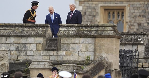 President Donald Trump and Britain's King Charles III walk together as they arrive for a Beating Retreat musical performance on the East Lawn of Windsor Castle, in Windsor, England, Wednesday, Sept. 17, 2025. (AP Photo/Evan Vucci)