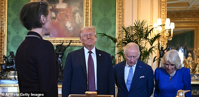US President Donald Trump, Britain's King Charles III and Britain's Queen Camilla view items from the Royal Collection in the Green Drawing Room at Windsor Castle, in Windsor, on September 17, 2025, during the US President's second State Visit. US President Donald Trump arrived in Britain for an unprecedented second State Visit, with the UK government rolling out a royal red carpet welcome to win over the mercurial leader. (Photo by ANDREW CABALLERO-REYNOLDS / AFP) (Photo by ANDREW CABALLERO-REYNOLDS/AFP via Getty Images)