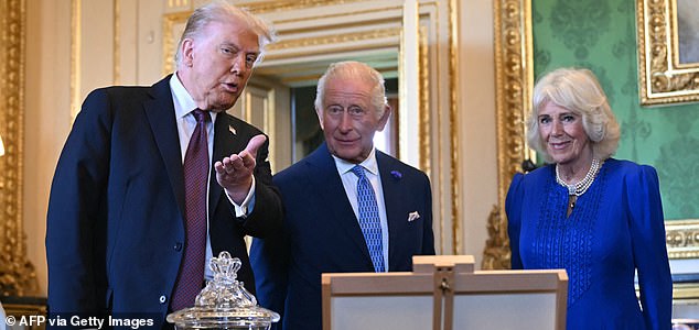 US President Donald Trump, Britain's King Charles III and Britain's Queen Camilla view items from the Royal Collection in the Green Drawing Room at Windsor Castle, in Windsor, on September 17, 2025, during the US President's second State Visit. US President Donald Trump arrived in Britain for an unprecedented second State Visit, with the UK government rolling out a royal red carpet welcome to win over the mercurial leader. (Photo by ANDREW CABALLERO-REYNOLDS / AFP) (Photo by ANDREW CABALLERO-REYNOLDS/AFP via Getty Images)