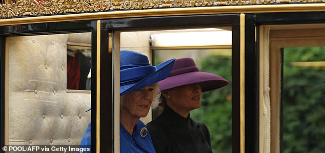 Britain's Queen Camilla (L) and US First Lady Melania Trump (R) travel in the The Scottish State Coach during a horse-drawn procession towards Windsor Castle, after landing in the grounds of Windsor Castle, in Windsor, on September 17, 2025, during a second State Visit. US President Donald Trump arrived in Britain for an unprecedented second State Visit, with the UK government rolling out a royal red carpet welcome to win over the mercurial leader. (Photo by Adrian Dennis / POOL / AFP) (Photo by ADRIAN DENNIS/POOL/AFP via Getty Images)