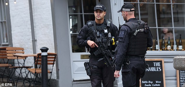 epa12384241 Armed police patrol at Windsor Castle in Windsor, Britain, 17 September 2025. Britain's King Charles III is to host US President Trump during his official state visit to the UK from 17 to 19 September 2025.  EPA/NEIL HALL