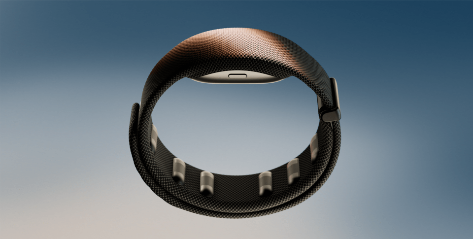 Black smart wristband with metallic clasp and sensors against a blue background.