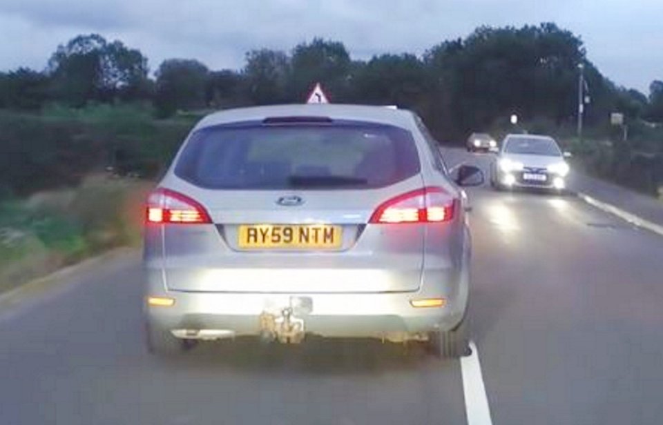 A silver Ford Mondeo with altered number plates being pursued by police.