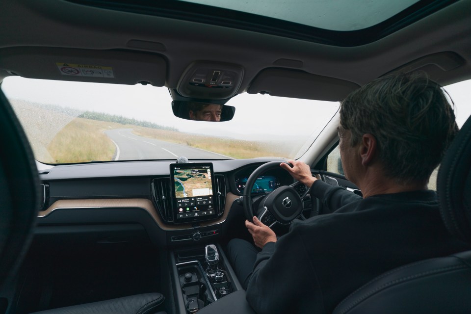 A person driving a Volvo XC60.