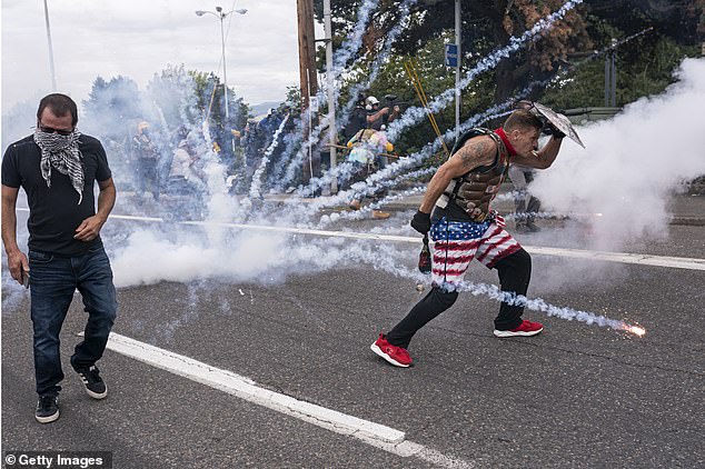 Trump Officials said individuals who have targeted law enforcement for carrying out Trump’s mass deportation operation could be labeled as domestic terrorists (pictured: far-right extremists react to fireworks thrown by Antifa counter-protestors in 2021)