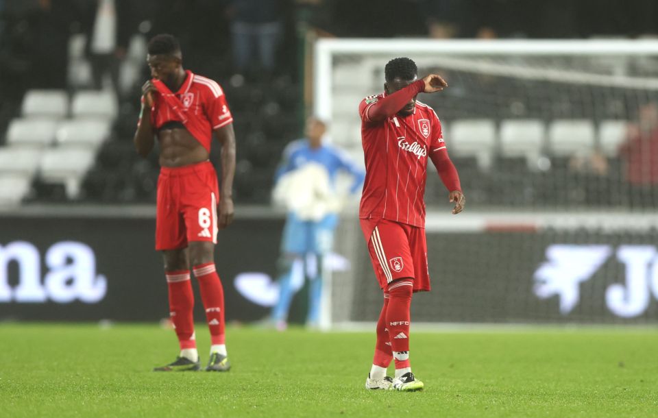 Nottingham Forest players looking dejected after a Swansea City goal.