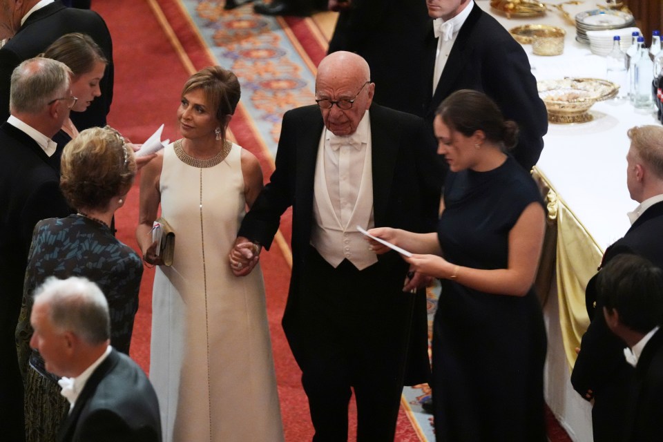 Rupert Murdoch and Elena Zhukova holding hands at Windsor Castle.