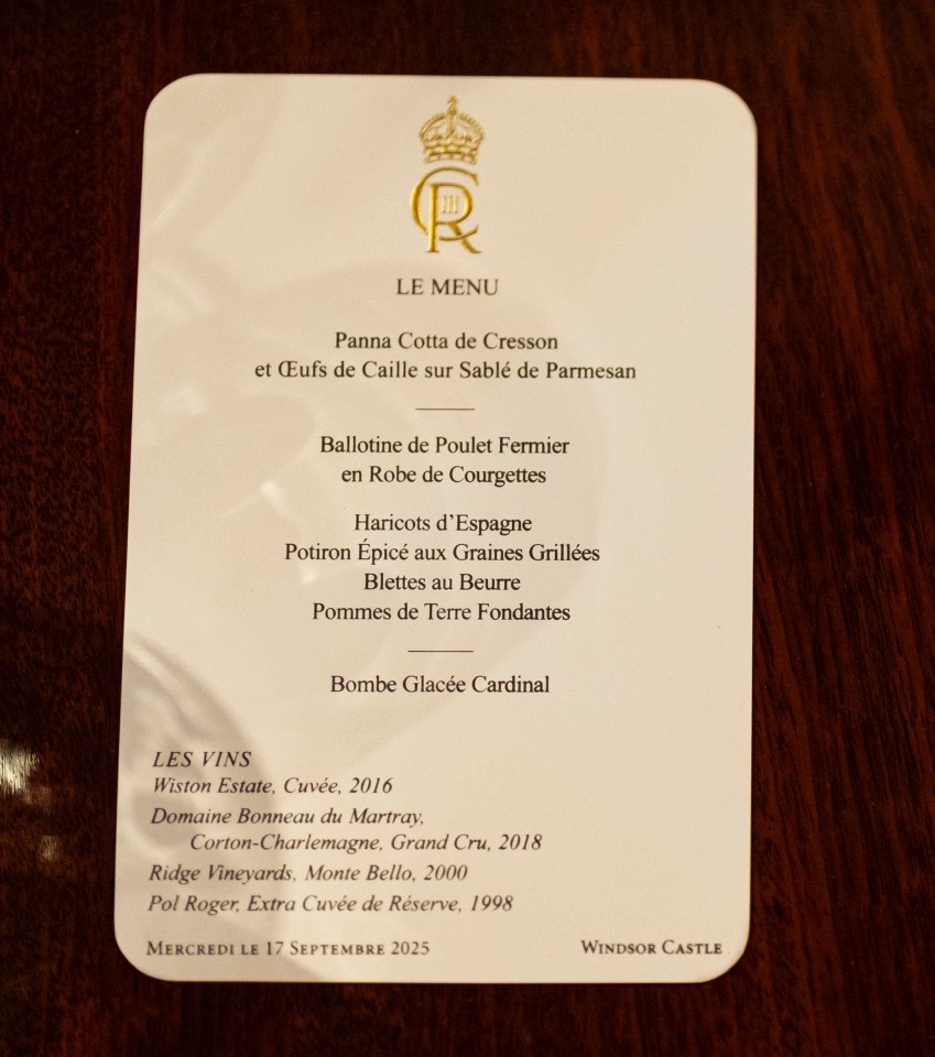 Place setting at Windsor Castle with a menu and golden silverware for "The King".