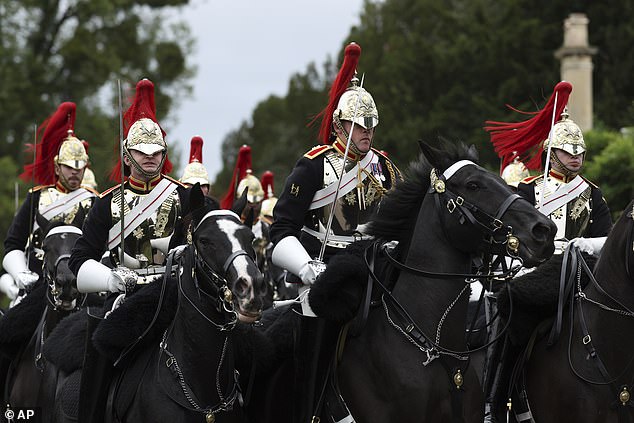 Members of the Blues and Royals Household Cavalry ride during yesterday's procession