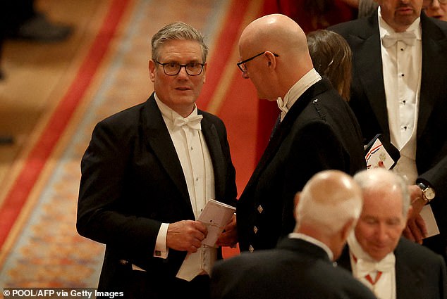 Prime Minister Keir Starmer (L) speaks to Scotland's First Minister John Swinney during the State Banquet at Windsor Castle