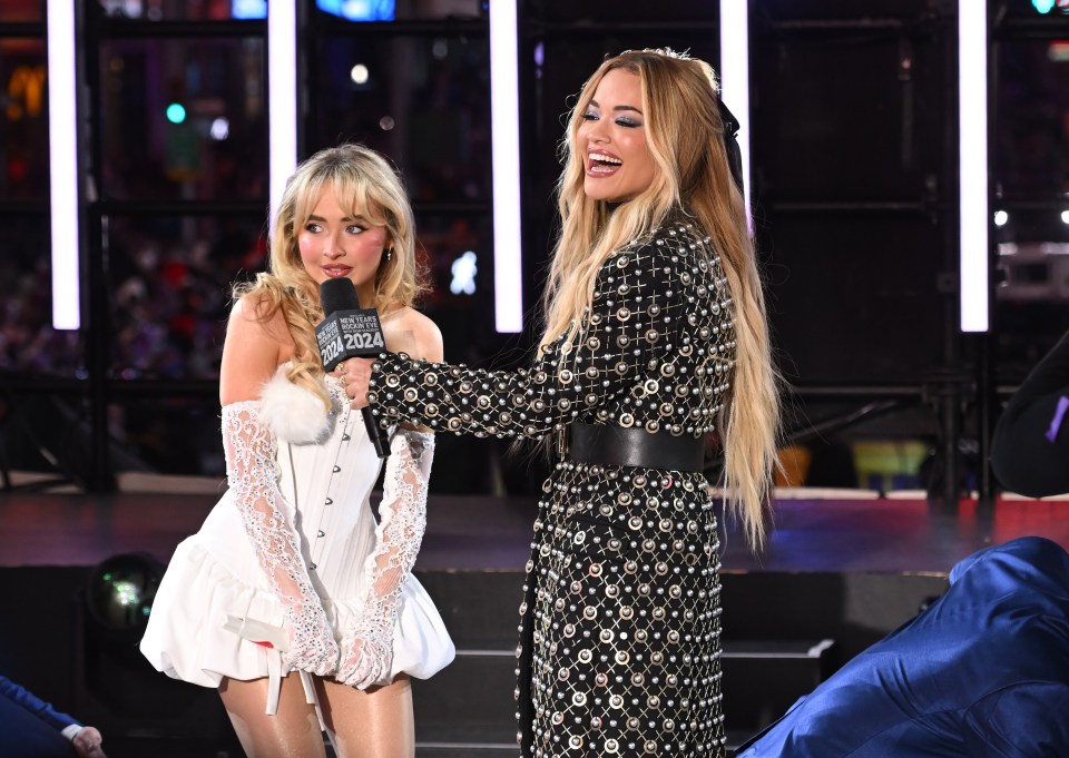 Sabrina Carpenter and Rita Ora speak onstage during the Times Square New Year's Eve 2024 Celebration.
