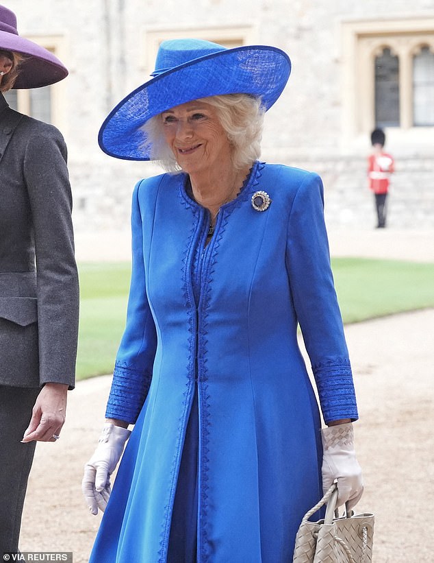 Queen Camilla teamed her blue dress and coat with a sentimental brooch experts have said was a 'meaningful statement of modern royal style'