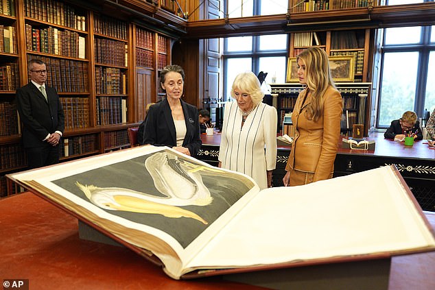 Melania Trump and Queen Camilla look at a book in the Royal Library at Windsor Castle today