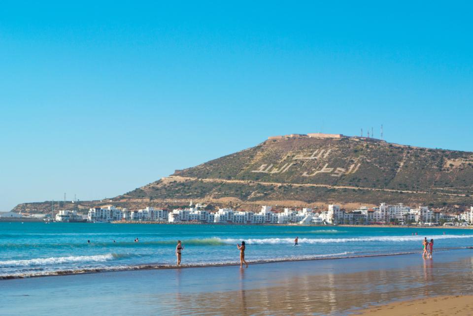 FWE1RT People in sea, swimming in water, city beach, Agadir, Souss, Morocco, northern Africa