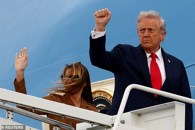 Donald Trump and first lady Melania Trump gesture as they board Air Force One to depart from London Stansted Airport