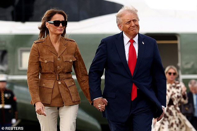 The US leader took hold of Melania's hand after the pair exited Marine One at Stansted Airport