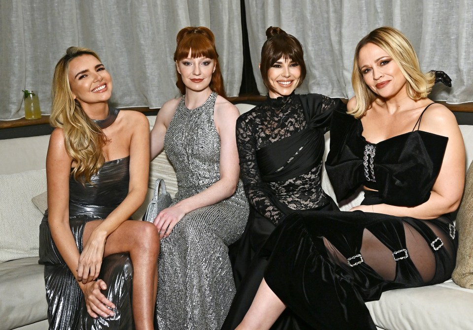 Four women, Nadine Coyle, Nicola Roberts, Cheryl, and Kimberley Walsh, sitting on a couch.