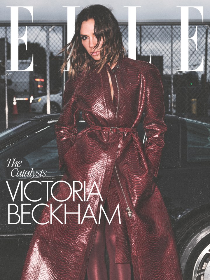Victoria Beckham on the cover of ELLE in an embossed red snakeskin coat, standing next to a car.