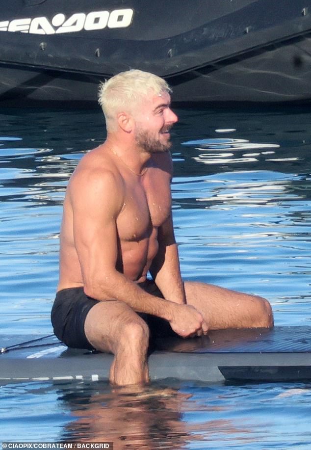Efron appeared to be having a blast as he dipped his legs into the ocean