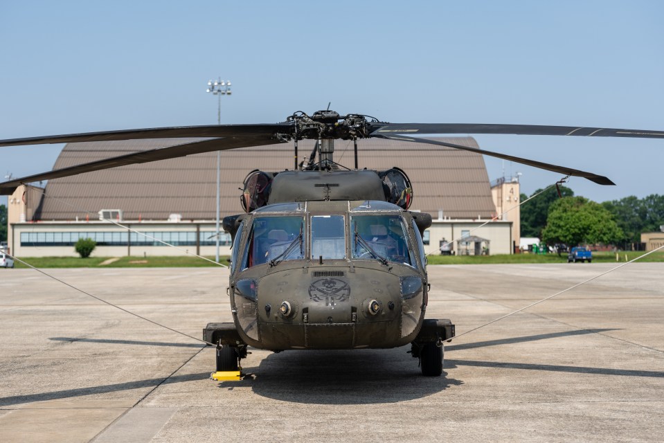 A Sikorsky UH-60 Black Hawk helicopter parked on an airfield.