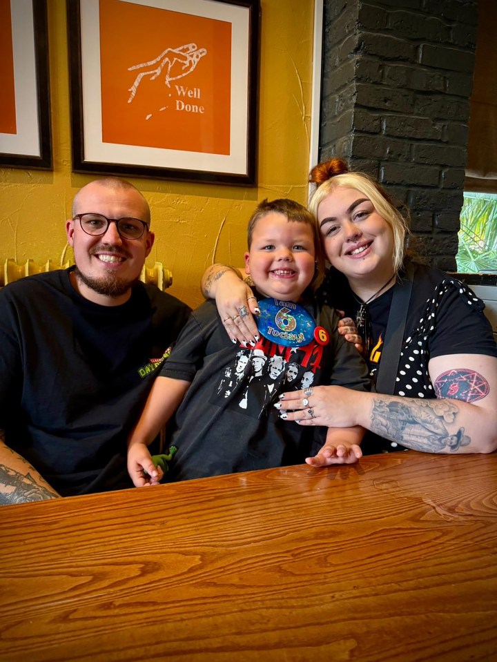 Family with a child wearing a "I am 6 Today!" badge.