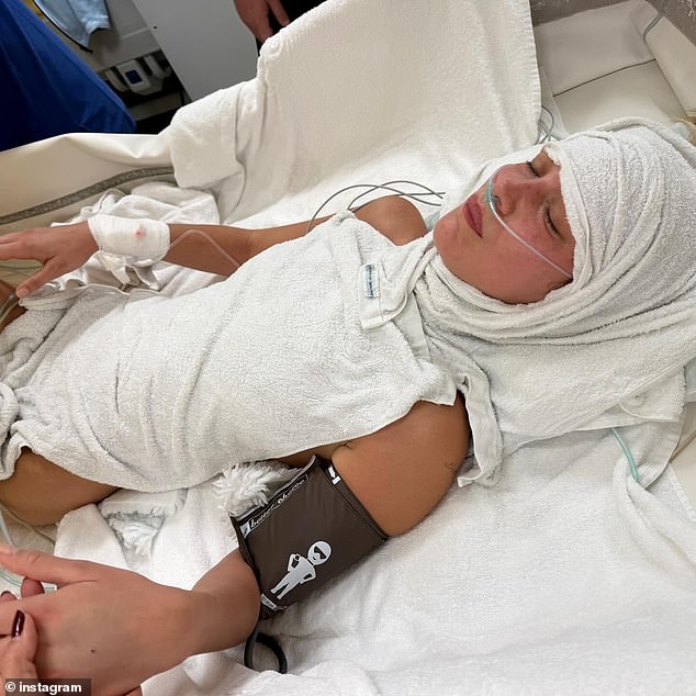 Wet towels were placed on Hadid's head and chest to cool down as she laid in bed