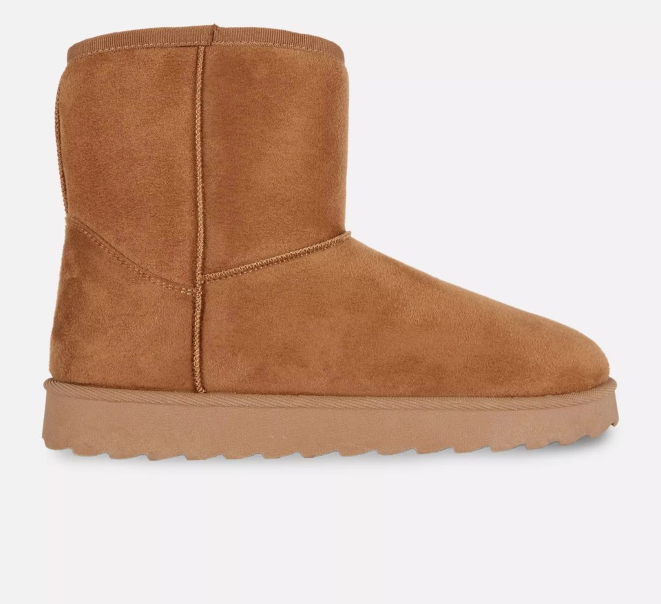 A single brown faux fur boot with a textured sole.