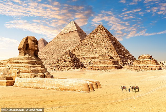 The photo tourists struggle to get: The Pyramids of Giza attract millions of visitors to Egypt every year, with the attraction crowded from dawn til darkness