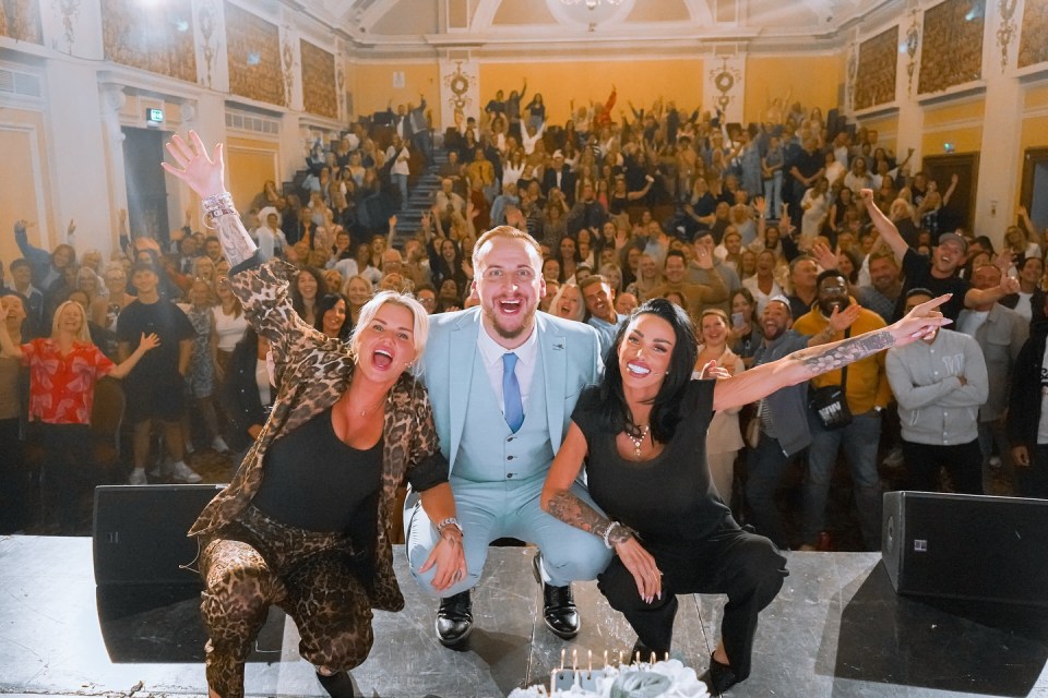 Kerry and Katie Price on tour, kneeling on stage in front of a cheering crowd.