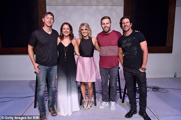 Songwriter Ashley Gorley, songwriter Hillary Lindsey, singer-songwriter Carrie Underwood, songwriter Zach Crowell and songwriter Brett James celebrate number one songs "Heartbeat" and "Church Bells" on August 11, 2016