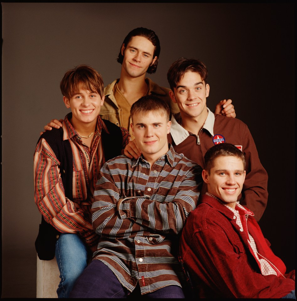 Take That boy band members Mark Owen, Howard Donald, Gary Barlow, Robbie Williams, and Jason Orange posing for a portrait.