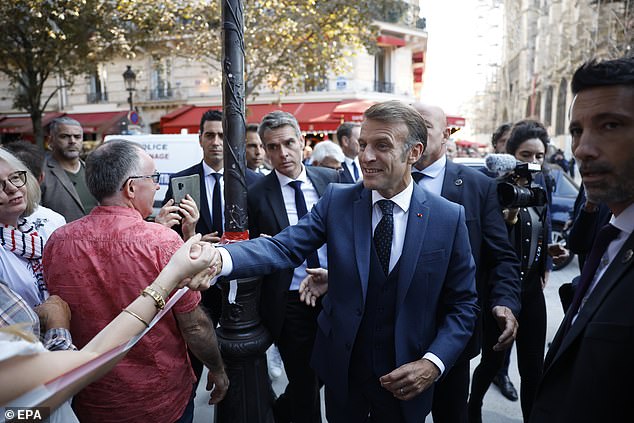 French President Emmanuel Macron (C) shakes hands after his visit at Notre Dame ahead of Local Heritage Days to celebrate the reopening of the cathedrals Towers to visitors in Paris, France, 19 September 2025