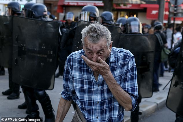 A man cover his mouth with his hand in Paris on September 18, 2025, during a day of nationwide strikes and protests called by unions over France's national budget
