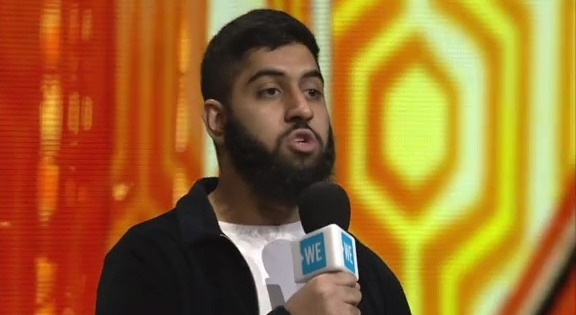 Musharaf Asghar, star of "Educating Yorkshire," speaking into a microphone.