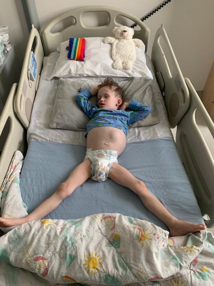Tommy Verbickas in a hospital bed with a distended abdomen.