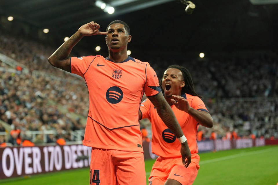 Marcus Rashford celebrates scoring for Barcelona with teammate Jules Kounde during a Champions League match.