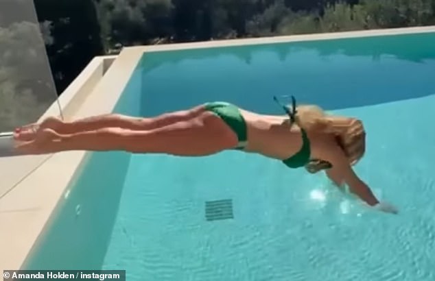 Amanda posed up a storm at the side of the pool before diving into the cooling water for a swim