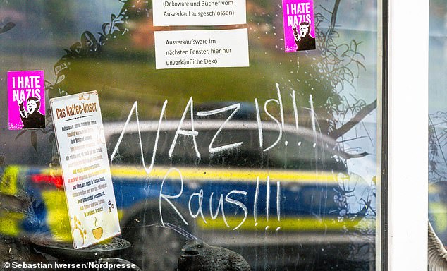 The sign has been since taken down after police came to investigate. Locals were outraged and left messages on the shop window