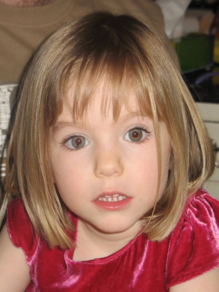 A young girl, Madeleine McCann, with shoulder-length blonde hair and light-colored eyes, wearing a red velvet top.